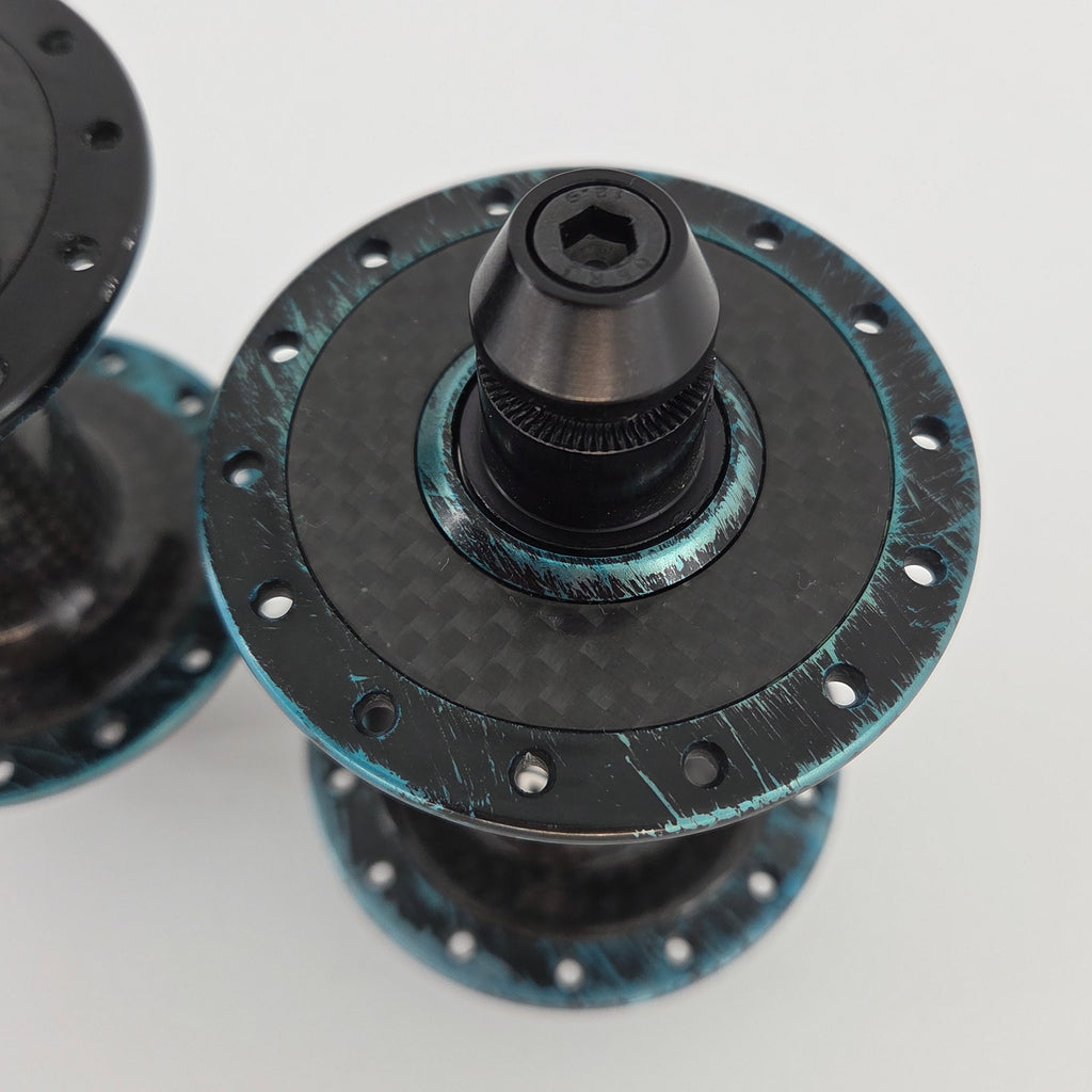 Reina High-Flange Carbon Track Hubs - Turquoise Anodized